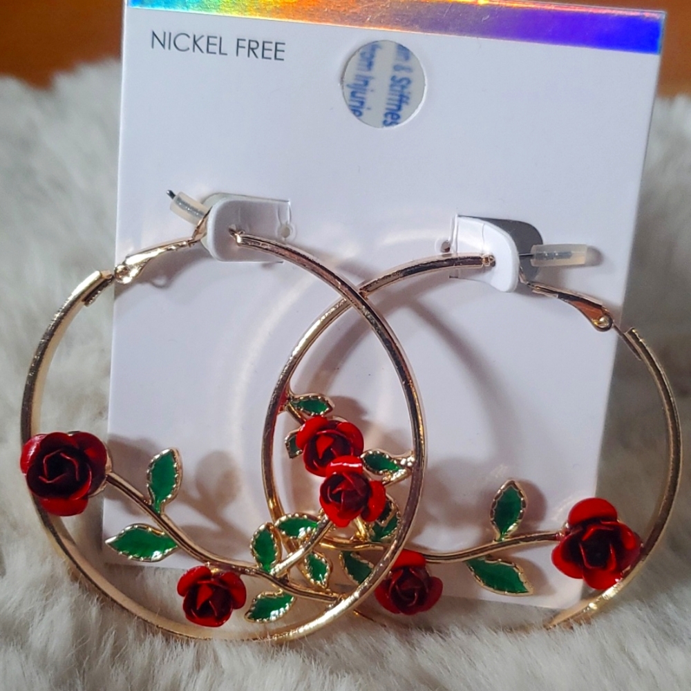 Gold hoop earrings with enamel rose pattern